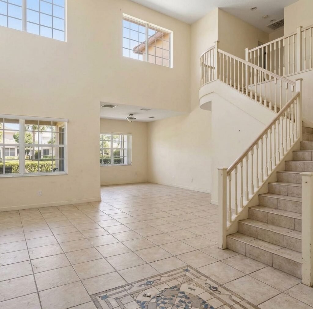 A clean, modern staircase with wood treads and an open-rail design.