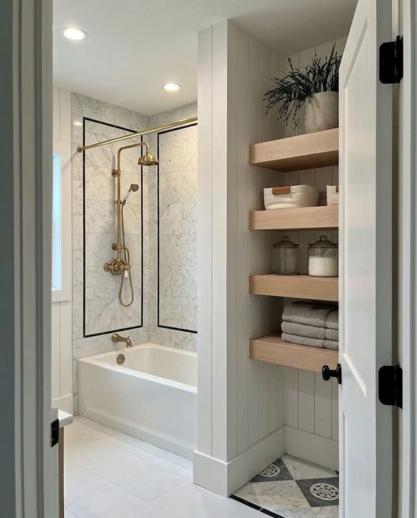 A close-up of a tiled shower wall with a recessed storage niche and modern fixtures.