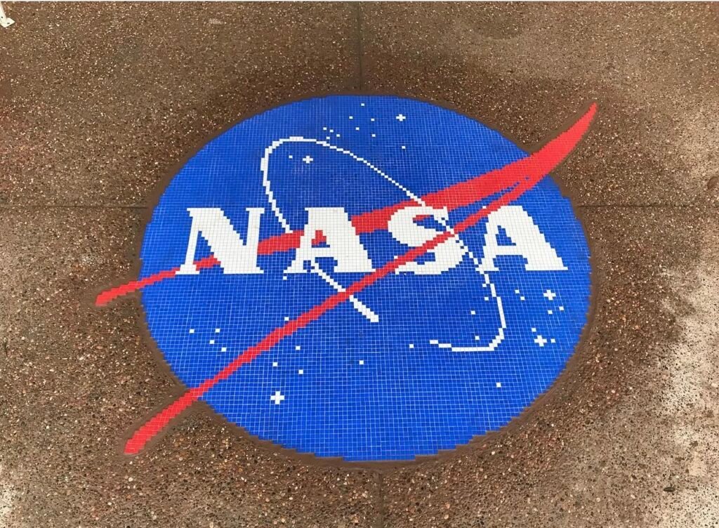 A fully custom mosaic recreating the NASA insignia in blue, white, and red tile, hand-set to match the original proportions.